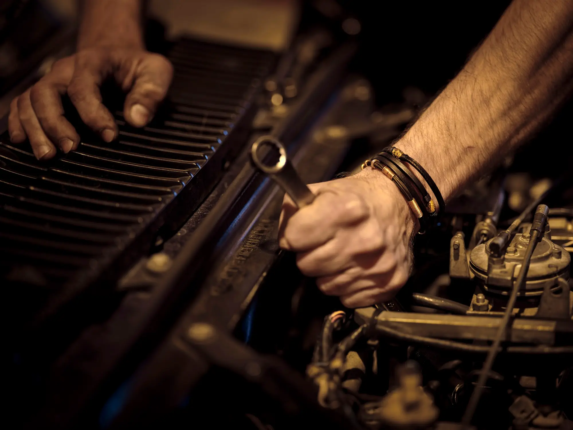 Mechanic tightening an engine bolt with a spanner, Brother Mechanics Greenford