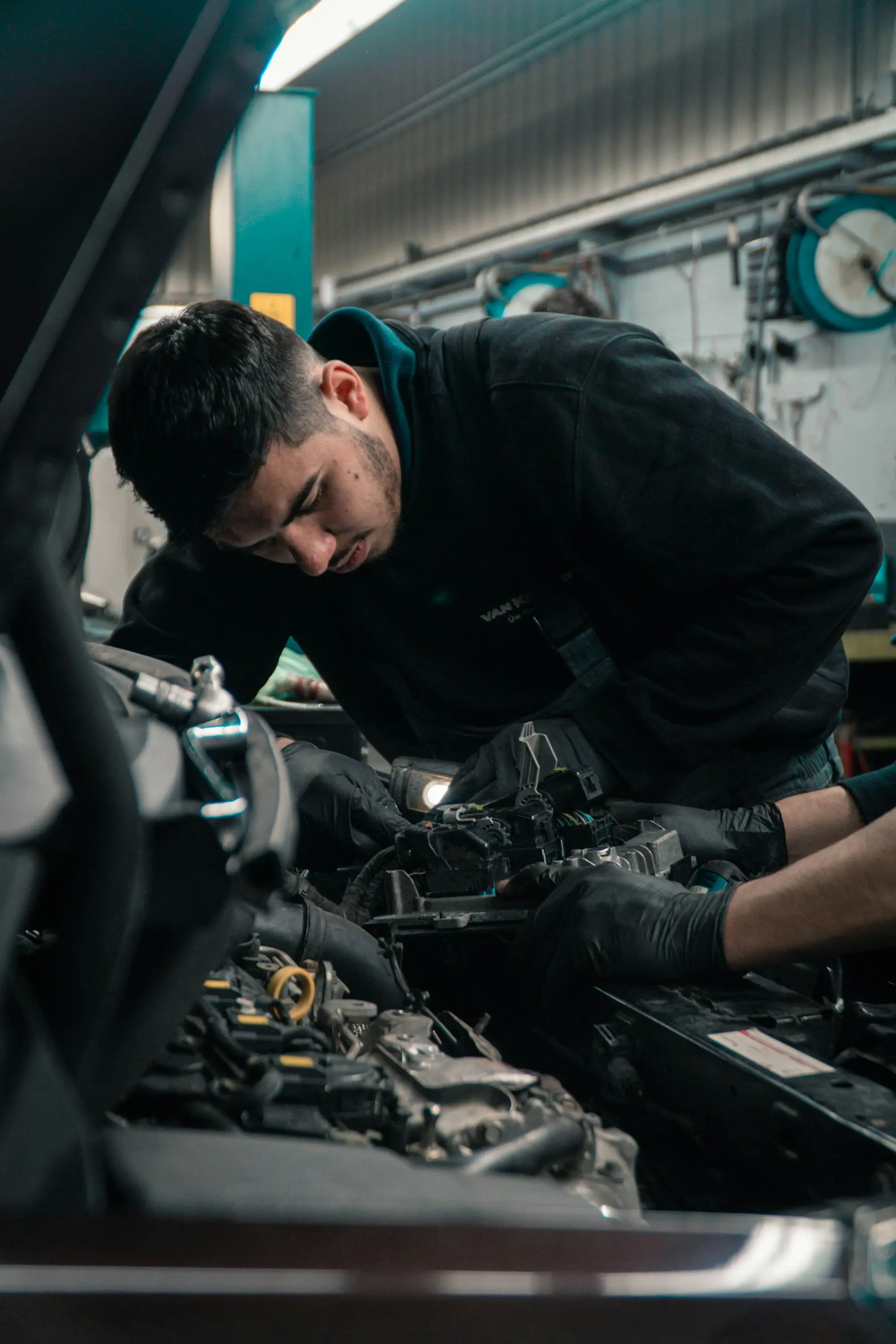 Mechanic working on a car engine at Brother Mechanics garage in Greenford
