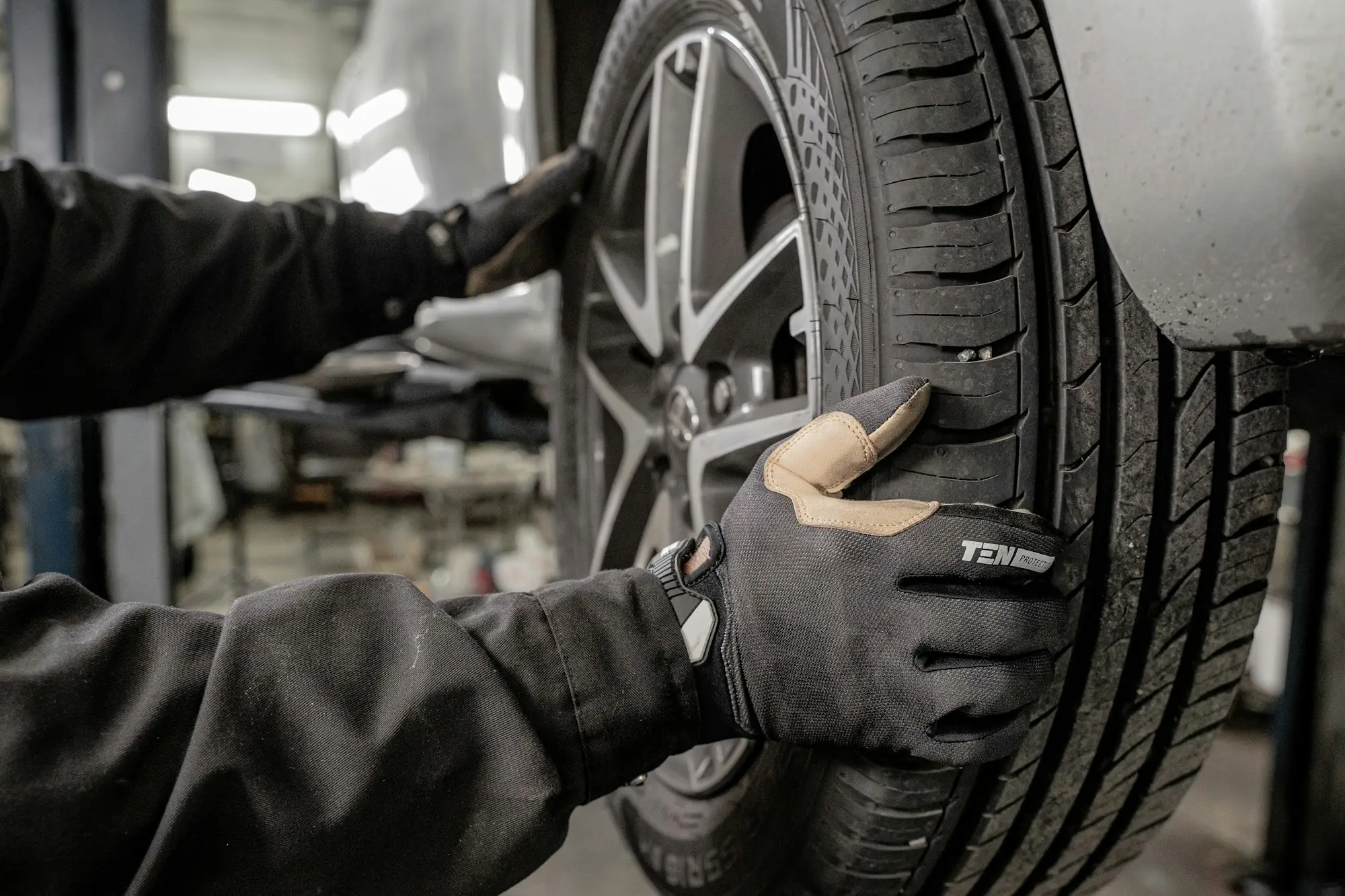 Mechanic fitting a wheel and tyre, Brother Mechanics Greenford