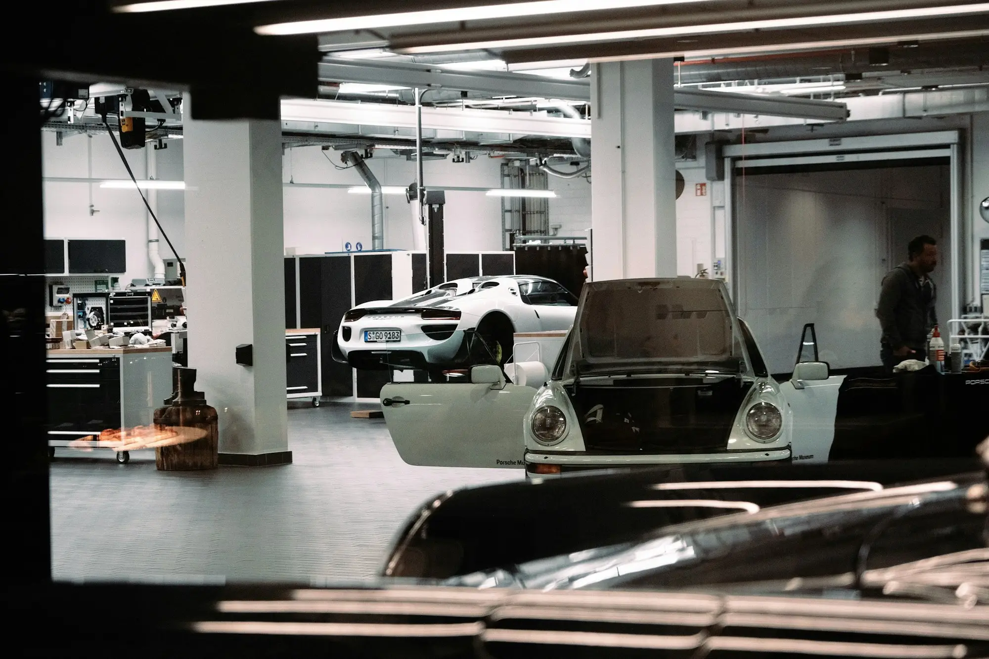 Cars on lifts inside a garage workshop, Brother Mechanics Greenford